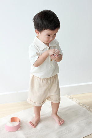 Child wearing Twinkle Planet Cream White polo shirt