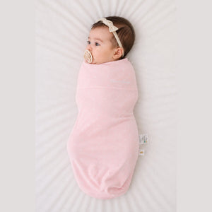 Baby sleeping in the Count & Countess Swaddle Bag, Pink Polka