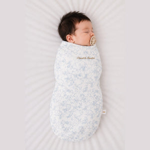 Baby sleeping in the Count & Countess Swaddle Bag, Toile De Jouy Blue
