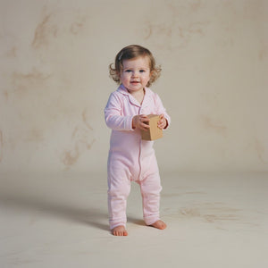 Baby wearing the Count & Countess Ballet Pink Pima romper sleepsuit