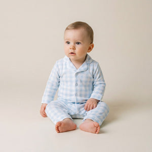 Baby wearing the Count & Countess Blue Gingham Pima romper