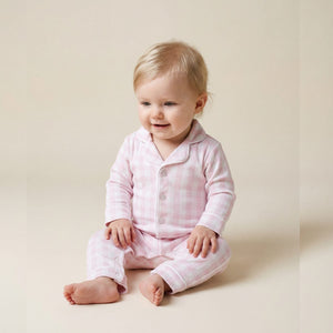 Baby wearing the Count & Countess Pink Gingham Pima romper