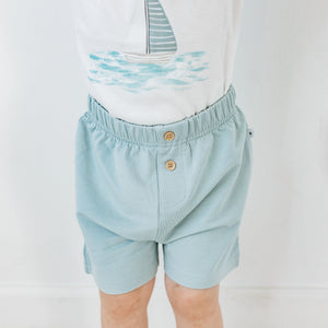 Toddler wearing Kays+Kins Stone Blue Bermuda shorts