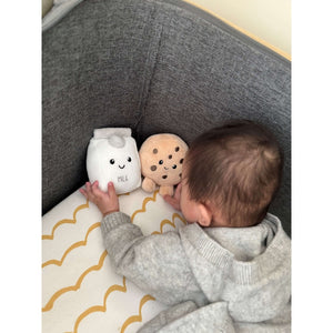 Baby holding Milk and Cookie plush toys