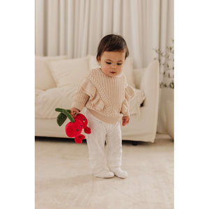 Toddler holding the Perfect Pairs cherries plush