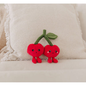 Perfect Pairs cherries plush toys on a cushion