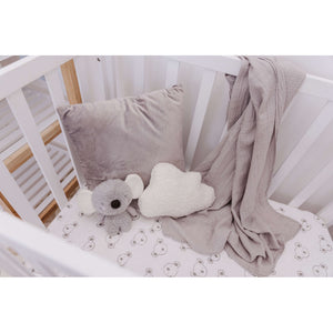 Coco the Koala plush in a cot