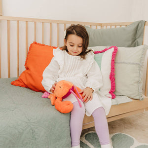 Child holding Libby the Lobster plush
