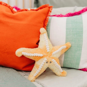 Sunny the Starfish plush on a bed