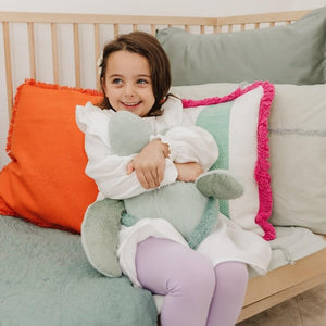 Child holding Toby the Turtle plush