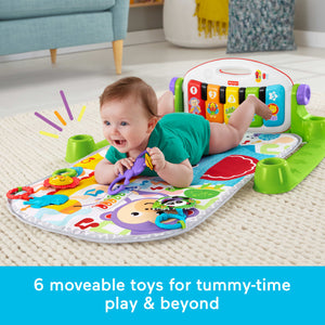Baby using the Kick and Play Piano Gym for tummy time