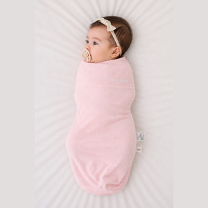 Baby sleeping in the Count & Countess Swaddle Bag, Pink Polka