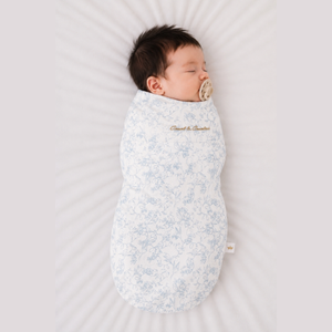 Baby sleeping in the Count & Countess Swaddle Bag, Toile De Jouy Blue