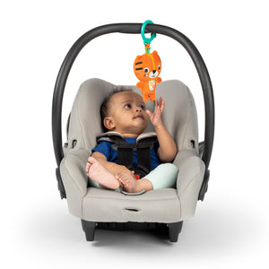 Tiger rattle clipped to an infant car seat handle