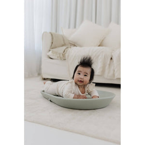 Baby lying on the sage Cuddle Changing Mat