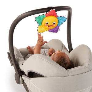Star Bright Symphony attached to an infant car seat handle