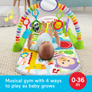 Baby lying under the green Fisher-Price Deluxe Kick and Play Piano Gym