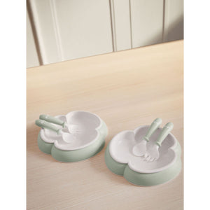 BabyBjörn Baby Plate, Spoon and Fork, 2 sets, Powder Green on a table