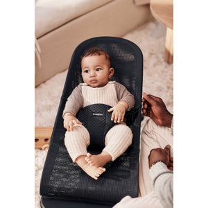 Baby resting in the BabyBjörn Bouncer Bliss in black mesh
