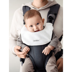 Baby wearing the BabyBjörn Bib for Baby Carrier Harmony
