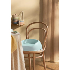 BabyBjörn Booster Seat in Mint Green on a dining chair