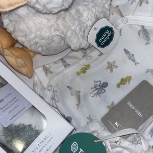 The Newborn Welcome Gift Luxe — close-up of the pieces in the box