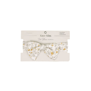 Baby wearing the Kays+Kins Wildflower Haze print pre-tied bow headband