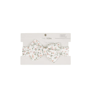 Baby wearing the Kays+Kins Wildflower Waltz print pre-tied bow headband