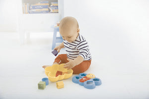 Baby playing with the Fisher-Price Butterfly Shape Sorter on the floor