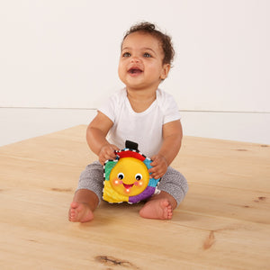 Baby holding the Star Bright Symphony plush star
