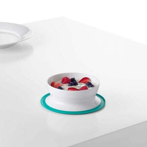 OXO Tot Stick and Stay Suction Bowl in Teal, suctioned to a table with fruit and yoghurt