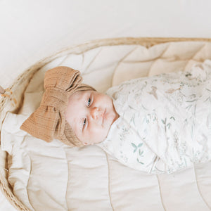 Baby wearing the Kays+Kins Chestnut pointelle topknot