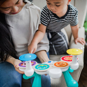 Two toddlers playing the Together in Tune wooden drums