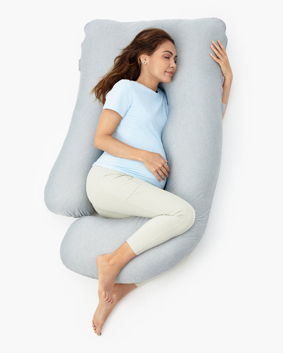 Momcozy U Shaped Cooling Fabric Pregnancy Pillow in blue, shown with a pregnant woman side sleeping inside it