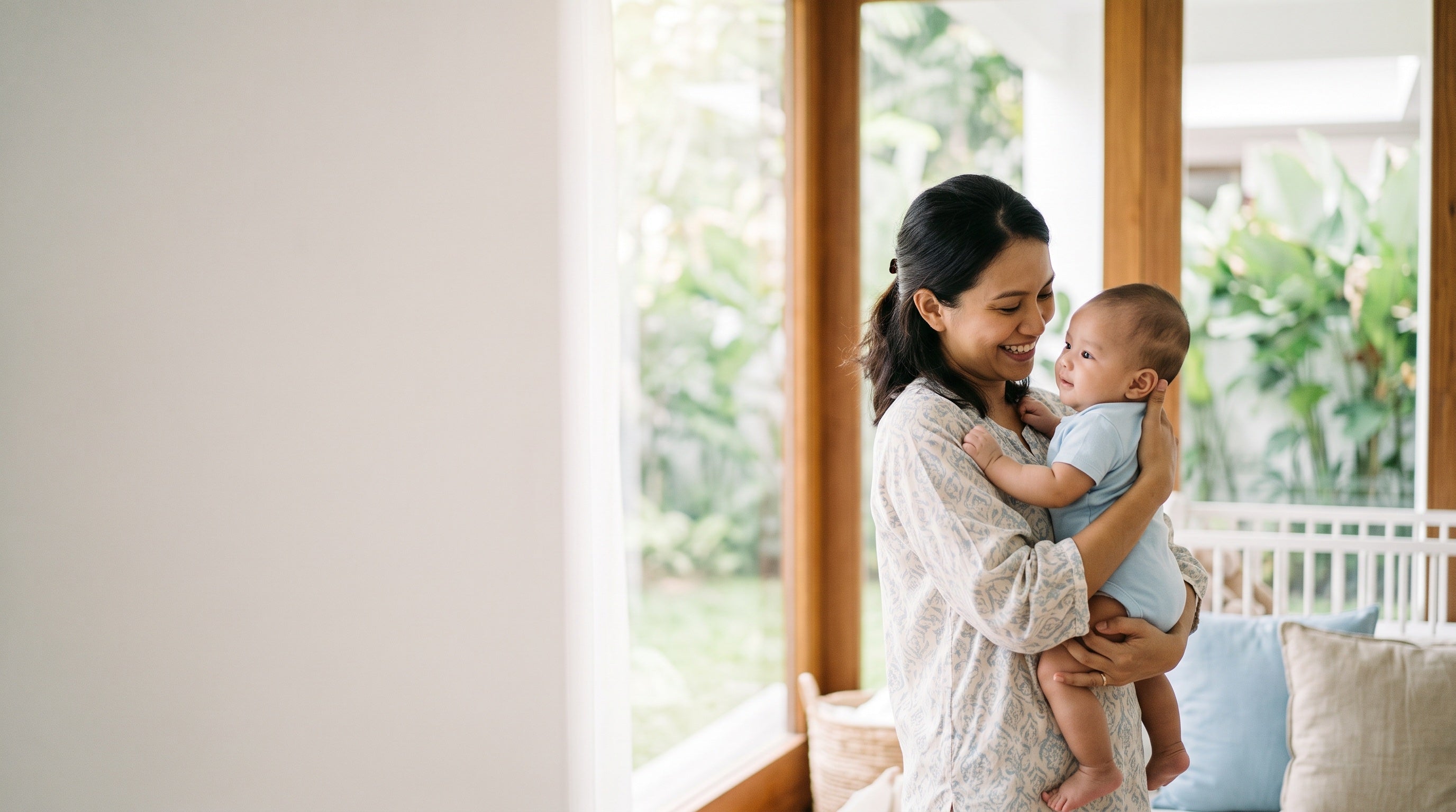 Mother holding her baby in a bright nursery